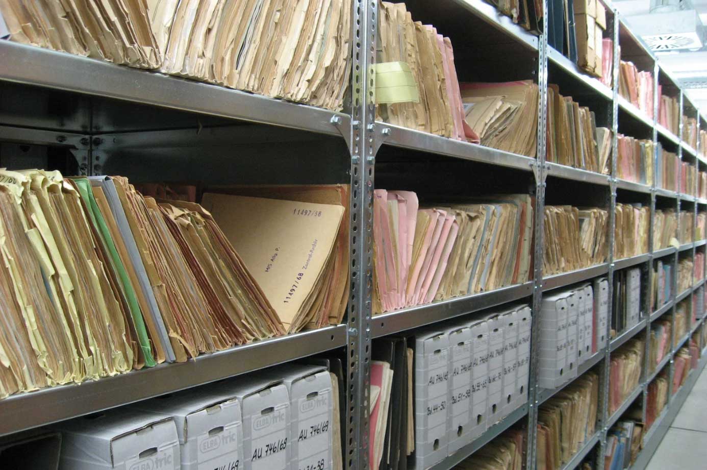 A room with paper files that needs to be transferred to digital files for future use.