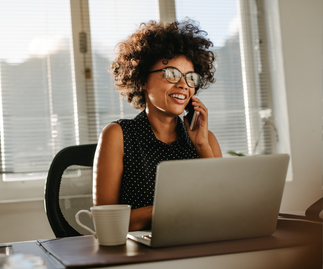 remote employee sitting at her desk and accessing her paperless W2 with ease
